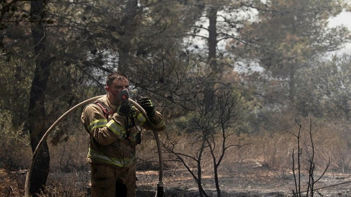 Israeli firefighter pictured after battling one of Israel's largest wildfires in years.