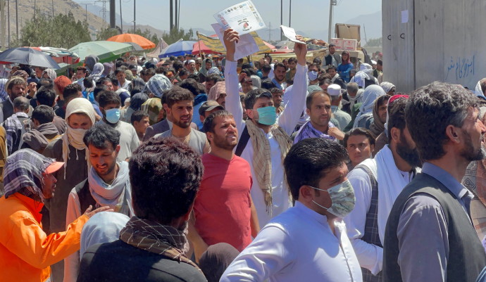 Crowds of people show their documents to US troops outside the airport in Kabul, Afghanistan August 26, 2021REUTERS/STRINGER
