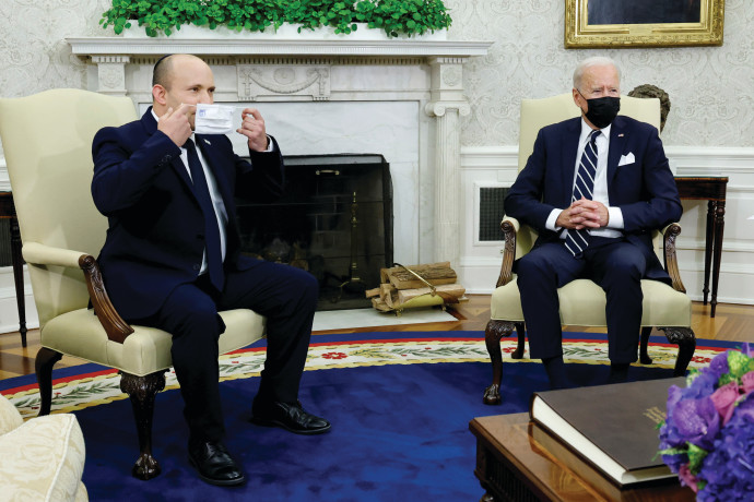 PRIME MINISTER Naftali Bennett holds a mask during a meeting with US President Joe Biden at the White House last month.REUTERS/JONATHAN ERNST