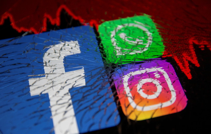 Facebook, Whatsapp and Instagram logos and stock graph are displayed through broken glass in this illustration taken October 4, 2021.REUTERS/DADO RUVIC