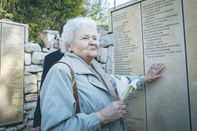 A WOMAN from Poland places her hand near the names of family members honored at Yad Vashem in 2018 as Righteous Among the Nations.NOAM REVKIN FENTON/FLASH90