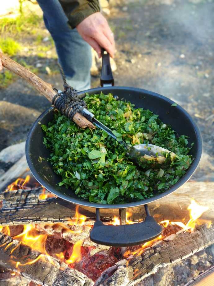 Hubeiza (mallow, saltwort) cooked on the fire with fried onions (Credit: OFEK RON CARMEL)
