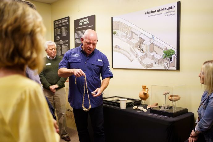 Visitors learning about slings and sling stones with Dr. Scott Stripling. (Credit: MIKE TURNER)