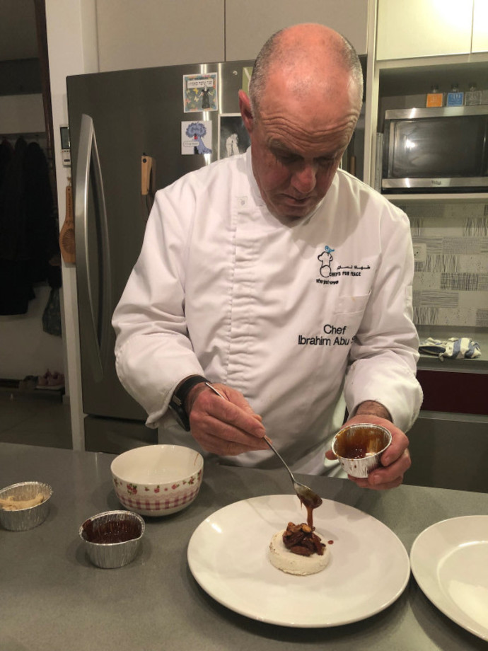 Pastry Chef Ibrahim Abusier making dessert (Credit: CARRIE HART / ALL ISRAEL NEWS)