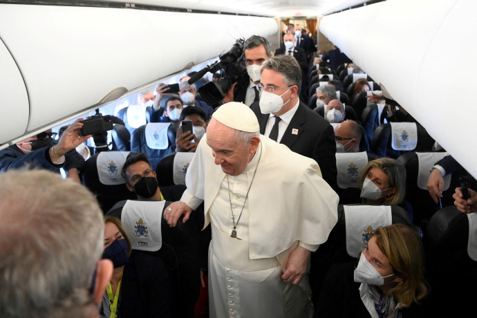 Pope Francis greets journalists aboard a plane on his way to Malta April 2, 2022. (Credit: VATICAN MEDIA/HANDOUT VIA REUTERS)