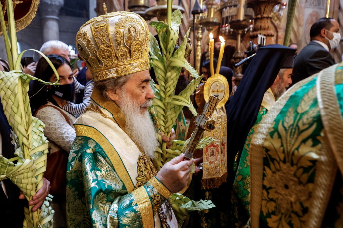 The Greek Orthodox Patriarch of Jerusalem, Theophilos III, leads a procession during Orthodox Palm Sunday, marking the start of Holy Week that ends on Easter Sunday in the Church of the Holy Sepulchre in Jerusalem's Old City April 17, 2022. (Credit: AMIR COHEN/REUTERS)