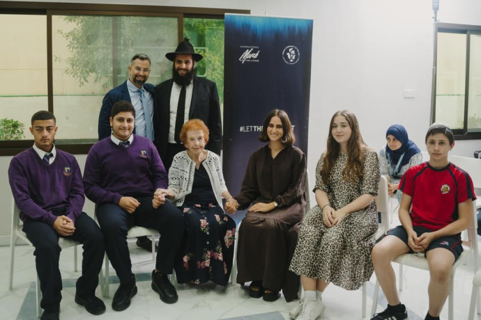 KRISTALLNACHT EDUCATION event in Dubai. in photo: Holocaust survivor Eve Kugler; UAE Chief Rabbi Levi Duchman; and Eitan Neishlos with Emirati children. (Credit: March of the Living)