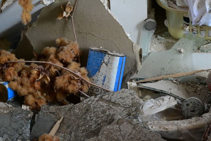  A Blue Box found among the ruins of a house destroyed by Hamas terrorists in Kibbutz Be’eri. Photo credit: Yossi Zeliger, (Credit: KKL-JNF Photo Archive)