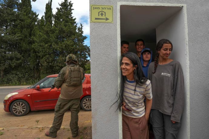 Israeli soldiers take position as civilians take cover during a Hezbollah attack near the Israeli border with Lebanon in northern Israel, May 19, 2026.