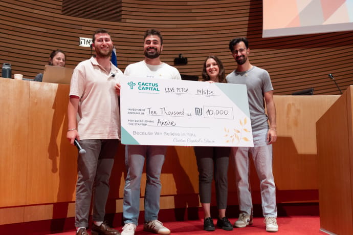 THE ANNIE founding team receiving an investment check from Cactus Capital.