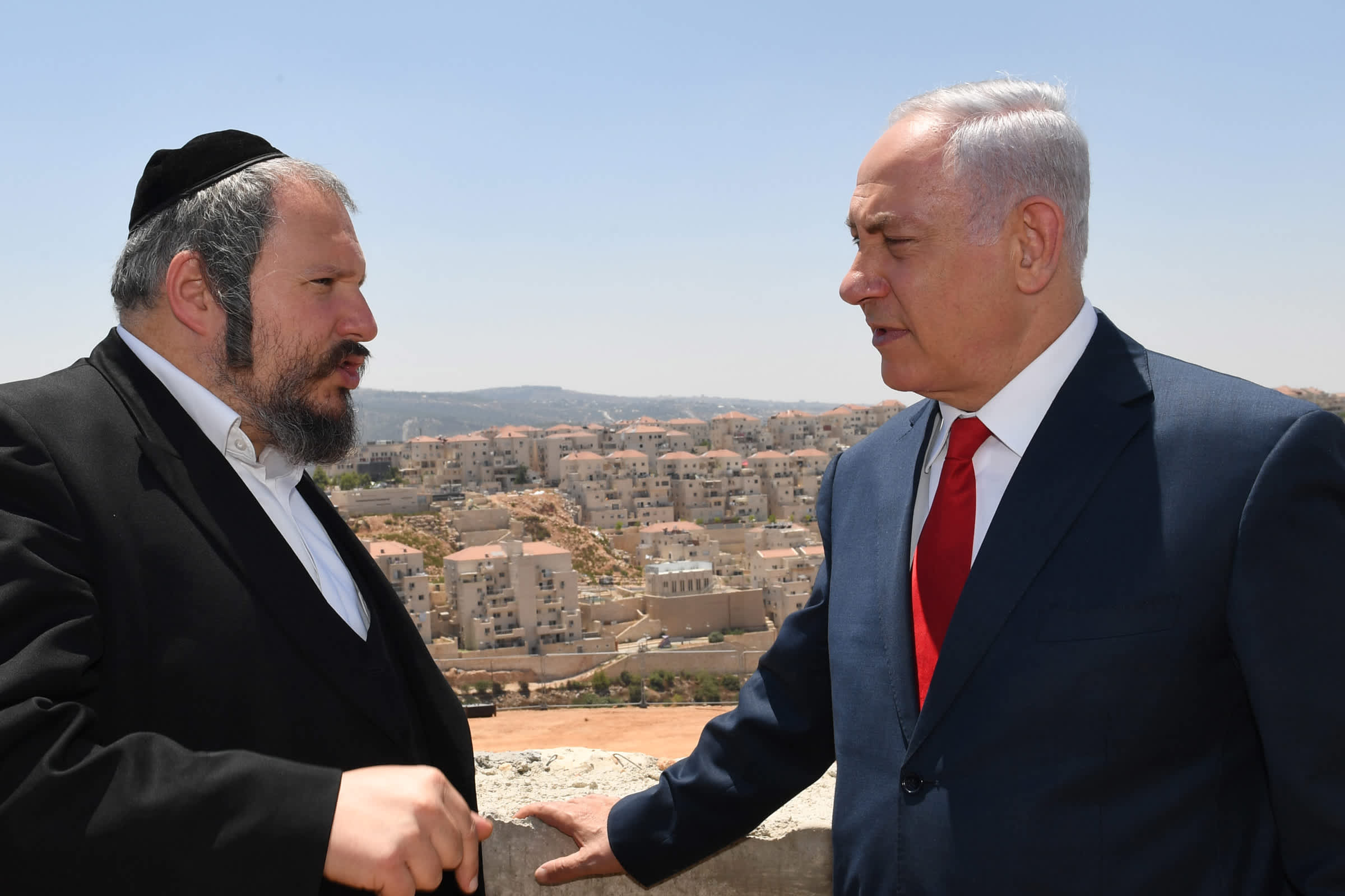 Prime Minister Benjamin Netanyahu speeks with Beitar Beitar Illit's mayor