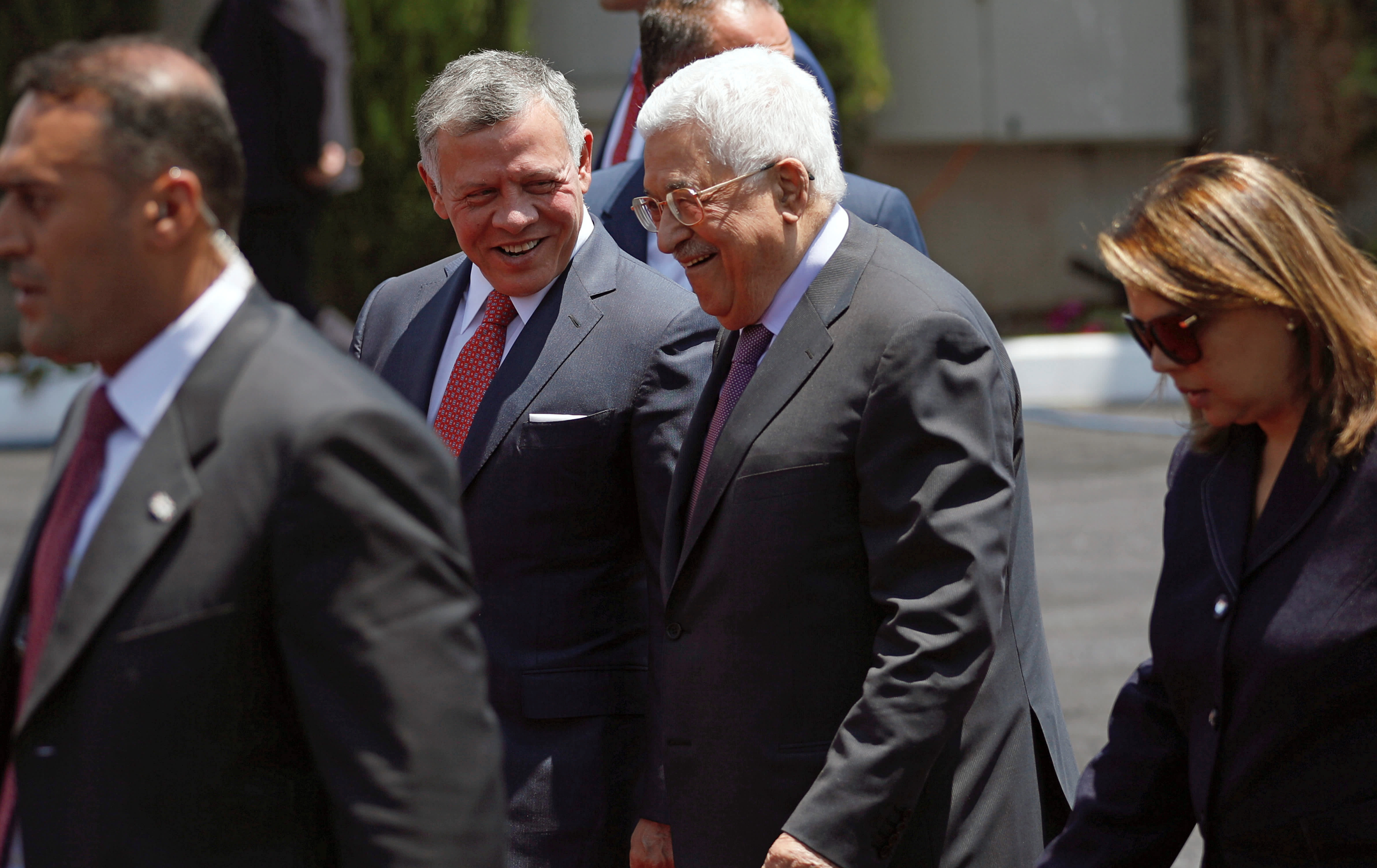 Jordan's King Abdullah II walks with Palestinian Authority President Mahmoud Abbas during a reception ceremony in the West Bank city of Ramallah
