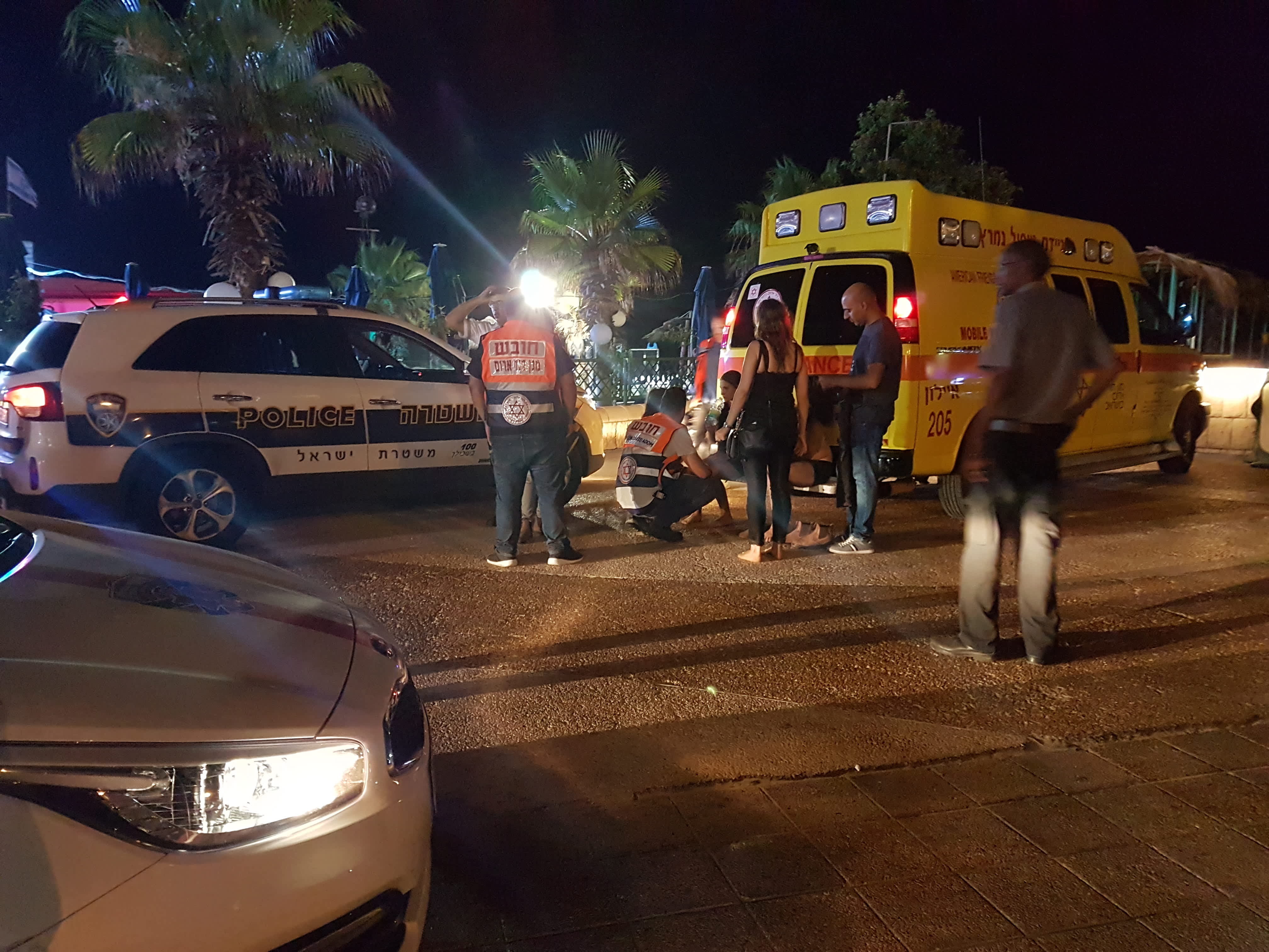 People get treatment after a near drowing in Rishon Lezion (credit: Becky Brothman)
