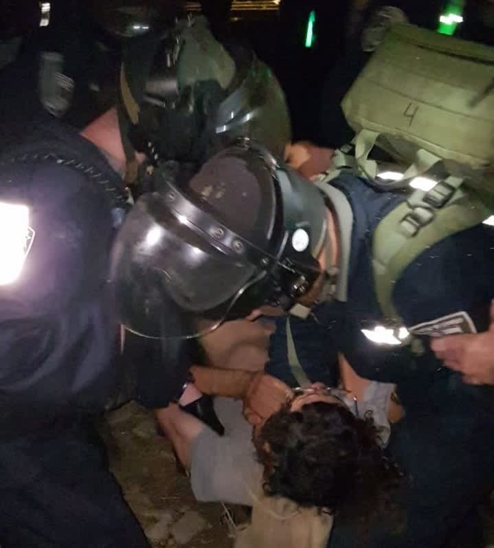 IDF and Border Police restrain a settler during a predawn raid in which two settler homes were demolished (credit: Hakol Hayehudi)