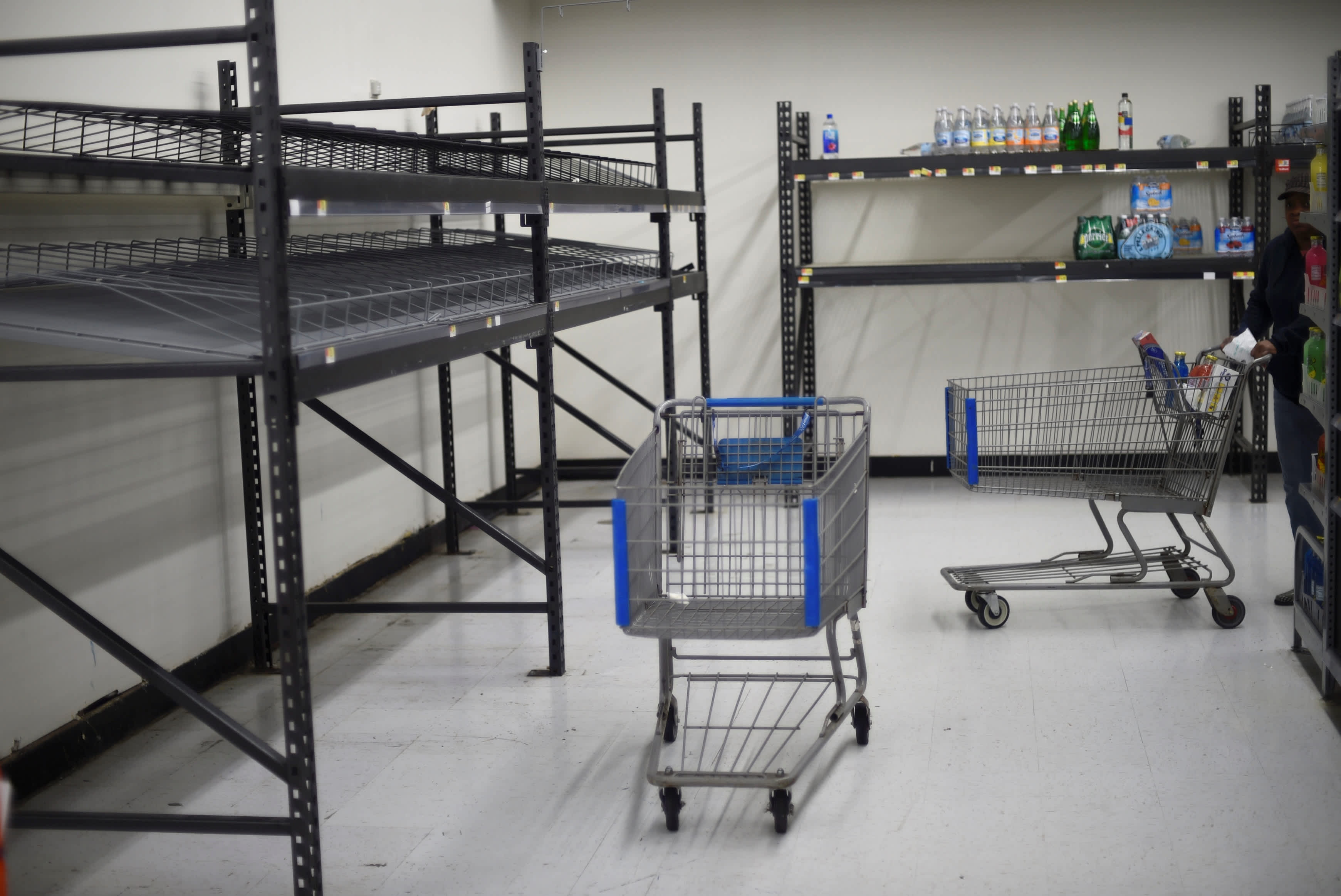 Shelves for water are seen almost empty in a supermarket after Hurricane, Mark Makela/ Reuters.  