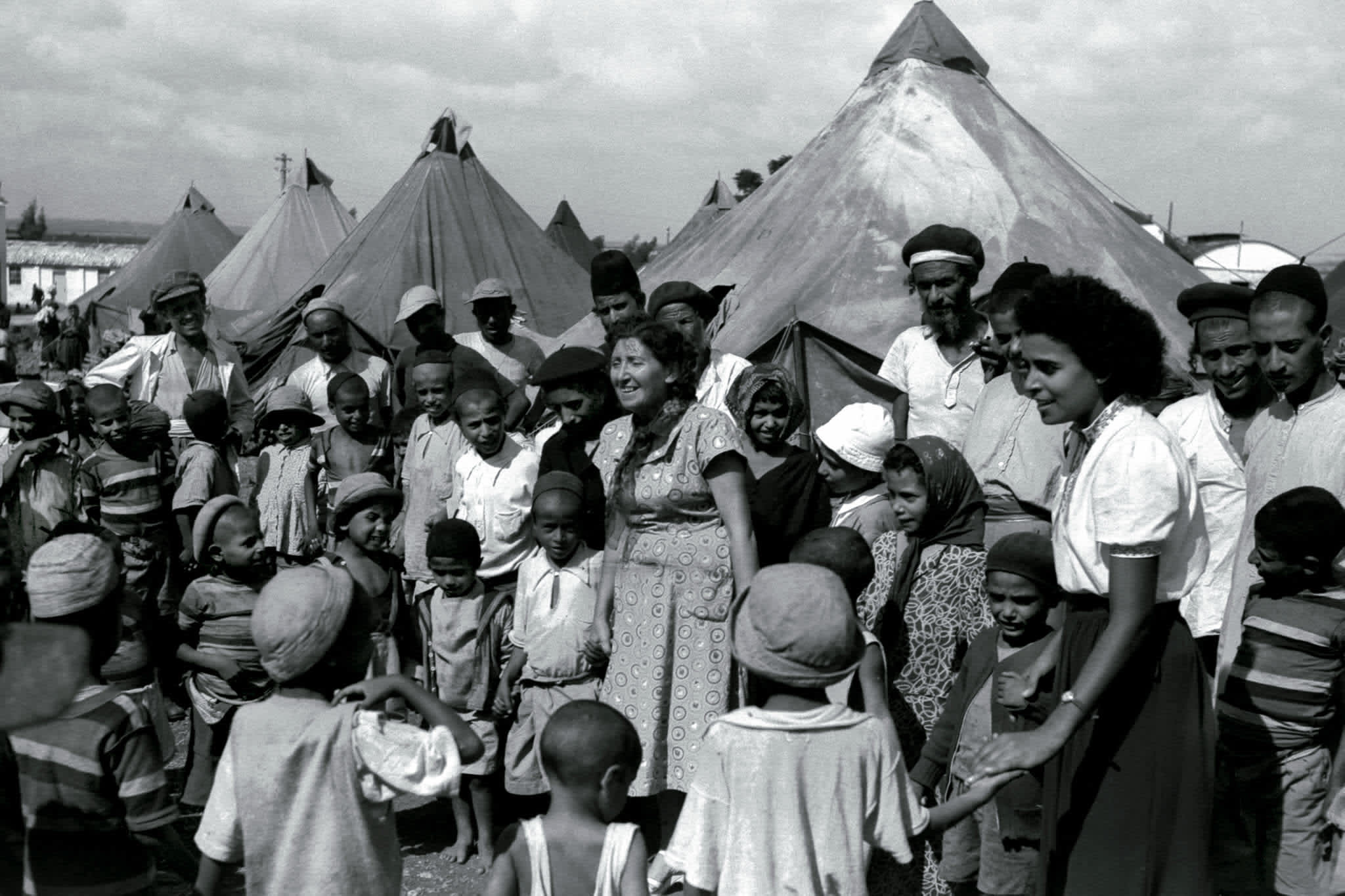 Jewish immigrants from Yemen in a tent encampment in 1949 as they are visited by Israeli nurses. (Reuters)