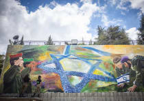  Israeli soldiers paint a mural with Israeli soldiers and the Star of David in Jerusalem