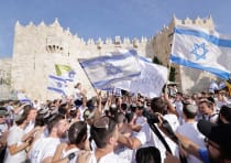  Participants in the Jerusalem Day Flag Parade gather outside the Old City's Damascus Gate