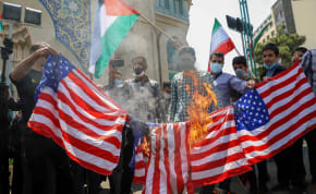 Iranians burn US flags during a protest to express solidarity with the Palestinian people amid a flare-up of Israeli-Palestinian violence, in Tehran, Iran May 18, 2021.