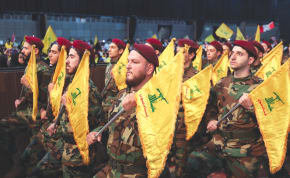  HEZBOLLAH MEMBERS hold flags during a rally marking the annual Hezbollah Martyrs’ Day, in Beirut’s southern suburbs, last month