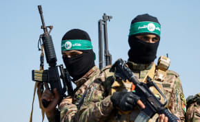  Palestinian fighters from the armed wing of Hamas take part in a military parade to mark the anniversary of the 2014 war with Israel, near the border in the central Gaza Strip, July 19, 2023.