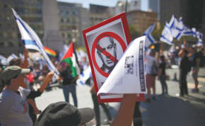  DEMONSTRATORS, INCLUDING one carrying a Palestinian flag, hold a protest against Prime Minister Benjamin Netanyahu during his meeting in San Fransisco with Elon Musk on September 18.
