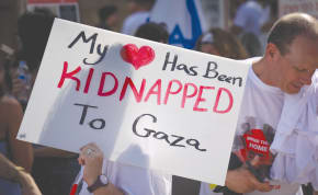 KFAR AZA residents call for the release of the hostages, outside Defense Ministry in Tel Aviv yesterday.