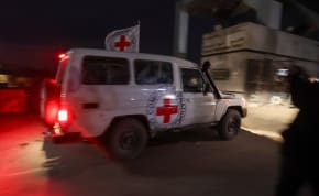 A Red Cross vehicle carrying hostages abducted by Hamas during the October 7 attack on Israel, arrives at the Rafah border, amid a hostages-prisoners swap deal between Hamas and Israel, in the southern Gaza Strip, November 28, 2023.