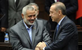  Turkey's Prime Minister Recep Tayyip Erdogan (R) and Hamas' Gaza leader Ismail Haniyeh shake hands during a meeting at the Turkish parliament in Ankara January 3, 2012