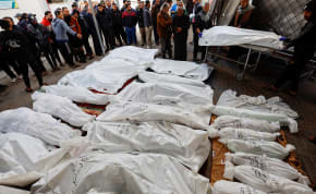  Mourners react next to the bodies of Palestinians killed in Israeli strikes, amid the ongoing conflict between Israel and the Palestinian Islamist group Hamas, at Abu Yossef Al-Najar hospital, in Rafah in the southern Gaza Strip December 12, 2023.