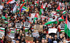  People take part in a protest to mark 100 days since the start of the ongoing conflict between Israel and the Palestinian Islamist group Hamas in Gaza during a march in London, Britain, January 13, 2024.