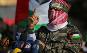  Abu Obaida, the spokesman of the Izz el-Deen al-Qassam Brigades, gestures as he speaks during an anti-Israel military show in the southern Gaza Strip November 11, 2019