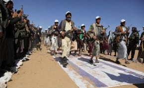 Tribesmen loyal to the Houthis march on U.S. and Israeli flags during a military parade for new tribal recruits amid escalating tensions with the U.S.-led coalition in the Red Sea, in Bani Hushaish, Yemen January 22, 2024.