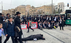 A group of ultra-Orthodox Jews blocked traffic and the light rail  in Jerusalem demonstrating against a Haredi draft into the IDF. February 26, 2024.