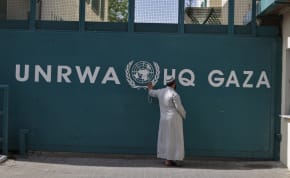  A Palestinian man waits outside of the UNRWA headquarters building in Gaza City on April 6, 2013.
