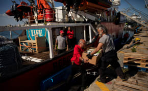  Open Arms members carry humanitarian aid for Gaza in a joint mission between NGOs Open Arms and World Central Kitchen at a port of Larnaca, Cyprus, March 9, 2024. 