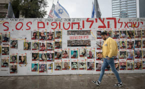  People walk by photographs of Israelis still held hostage by Hamas terrorists in Gaza, in Tel Aviv. March 19, 2024