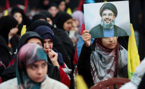  A supporter of Lebanon's Hezbollah leader Sayyed Hassan Nasrallah holds his picture during a rally commemorating the group's late leaders in Beirut's southern suburbs, Lebanon February 16, 2024.