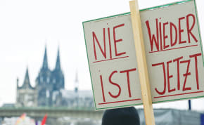  A DEMONSTRATOR holds a sign that reads “Never Again is Now” during a protest against right-wing extremism and the far-Right opposition Alternative for Germany (AfD), in Cologne, in January. 