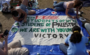  Students at Columbia University paint a response to a message written by Palestinians in Rafah thanking students for their support as they continue to maintain a protest encampment on campus in support of Palestinians, during the war between Israel and Hamas, April 28, 2024. 