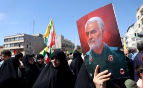  An Iranian woman holds a poster of senior Iranian military commander General Qassem Soleimani during a rally marking Quds Day and the funeral of members of the Islamic Revolutionary Guard Corps who were killed in a suspected Israeli airstrike on the Iranian embassy complex in the Syrian capital Dam