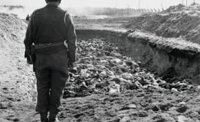  FINAL DIGNITY: Jewish chaplain Rev. Leslie Hardman stands over prisoners’ bodies in a mass grave for burial after the liberation of Bergen-Belsen by units of the British 11th Armoured Division, on April 23, 1945, near Celle, Germany.
