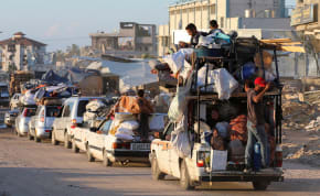 Displaced Palestinians, who fled Rafah after the Israeli military began evacuating civilians from the eastern parts of the southern Gazan city, ahead of a threatened assault, amid the ongoing conflict between Israel and Hamas, travel on a vehicle, in Khan Younis in the southern Gaza Strip May 6, 202
