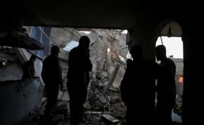  A Palestinian man inspects a house hit in an Israeli strike in Rafah, in the southern Gaza Strip, May 7, 2024