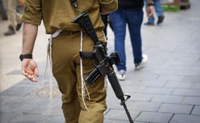  An IDF soldier is seen wearing a Jewish tzitzit while carrying a weapon in Jerusalem, May 13, 2024