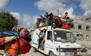  Displaced Palestinians travel in a vehicle as they flee Rafah, after Israeli forces launched a ground and air operation in the eastern part of southern Gaza city, amid the ongoing conflict between Israel and Hamas, in Rafah, in the southern Gaza Strip May 12, 2024.
