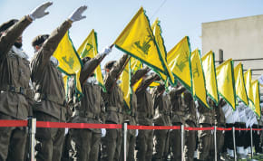  HEZBOLLAH OPERATIVES salute during the funeral of comrades killed in an Israeli strike, in Shehabiya, south Lebanon, April 17.