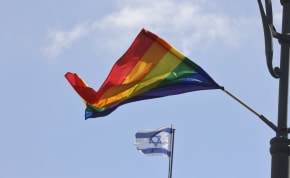  The LGBTQ+ rainbow flag is seen flying along with the flag of Israel during Gay Pride Parade in Jerusalem, May 30, 2024