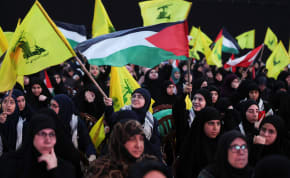  Supporters wave flags as they wait for Lebanon's Hezbollah leader Sayyed Hassan Nasrallah to speak, April 8, 2024.