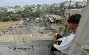  A Palestinian man views the site of an Israeli strike on a house, in the central Gaza Strip, June 3, 2024